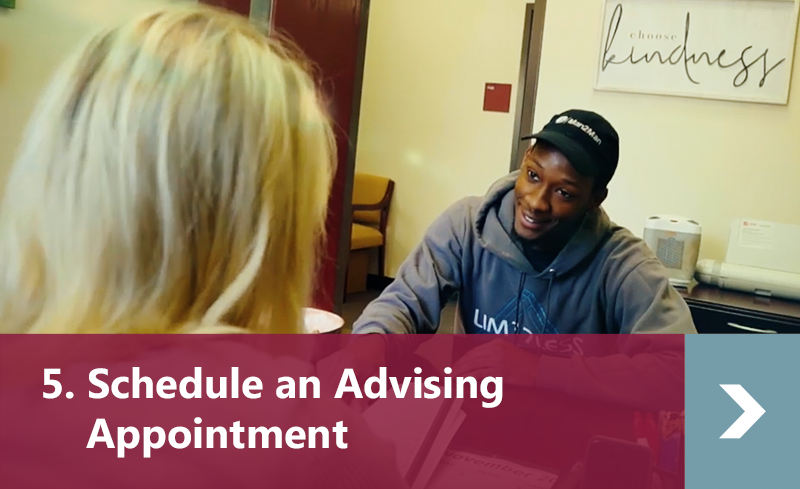 5. Schedule an Advising Appointment - Male student gets advice from female advisor in office.
