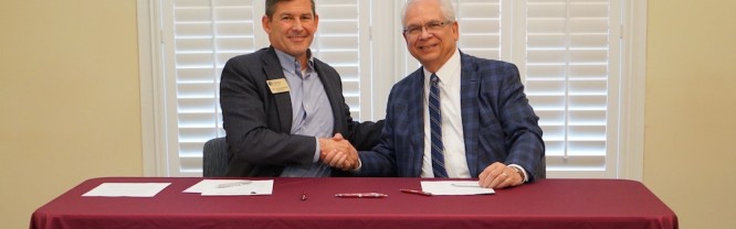 Jeff Smith, CEO (right) of Piedmont HealthCare signs an Apprenticeship Iredell Partnership with Dr. Tim Brewer, president of Mitchell Community College (left).