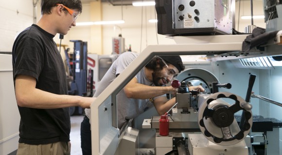 Students work on a CNC machine in Mitchell's Machine Shop