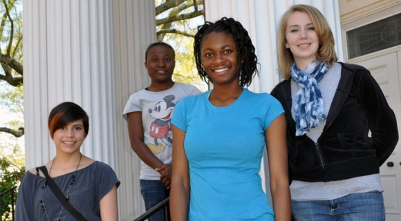Students pose on the front steps for a photo