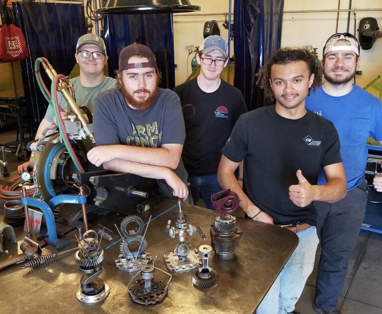 Mitchell's Welding Technology students standing with trophies created for Cars on Campus.